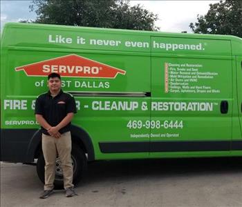Male employee, Josh one of our Technicians next to green SERVPRO van