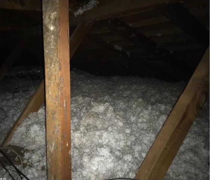 soot covering the interior of an attic crawlspace